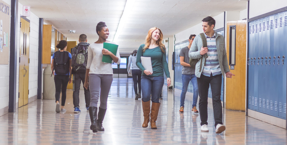 Diverse group of students walking together down the hallway in Smithson Valley High School