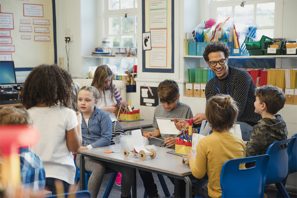 Teacher and elementary school students enjoying a fun activity in the classroom